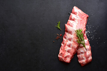 Raw pork ribs with ingredients for cooking. Top view with copy space.