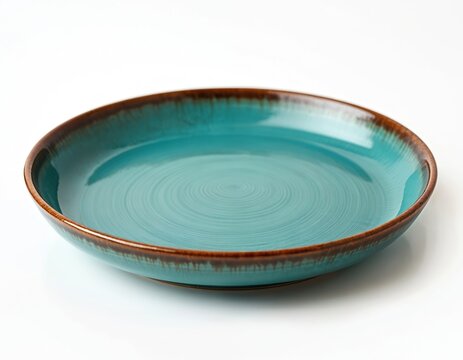 Ceramic turquoise plate on white background. Clean, empty dish has brown edge. Round crockery bowl isolated. Kitchenware concept for restaurant menu.