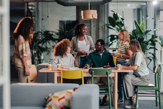 Diverse business team collaborating in modern office meeting