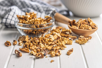 Peeled walnut kernels on white table.