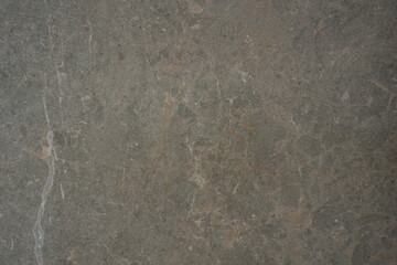dull gray textured stone surface background with diagonal white and brown veins and scratch marks concept of architecture, construction, tile manufacturing