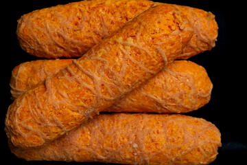 Top View of Golden Fried Corn Cheese Sticks (Tequeños or Sorullitos) Served on a Black Rectangular Plate on Dark Background
