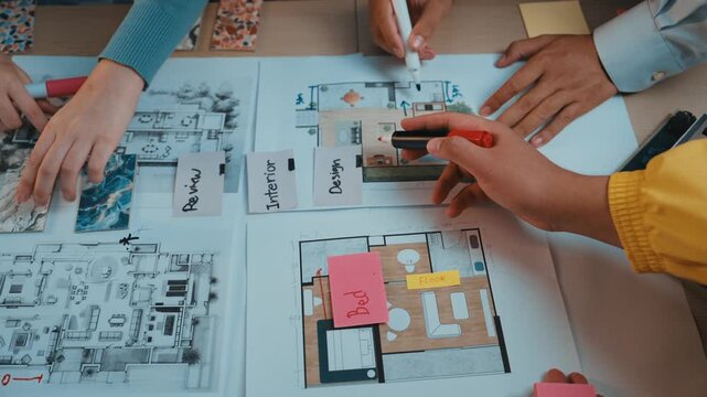 A dynamic interior design planning session showcasing hands engaged in discussions with colorful notes and sketches on the table. The collaborative environment promotes innovation. SACTR