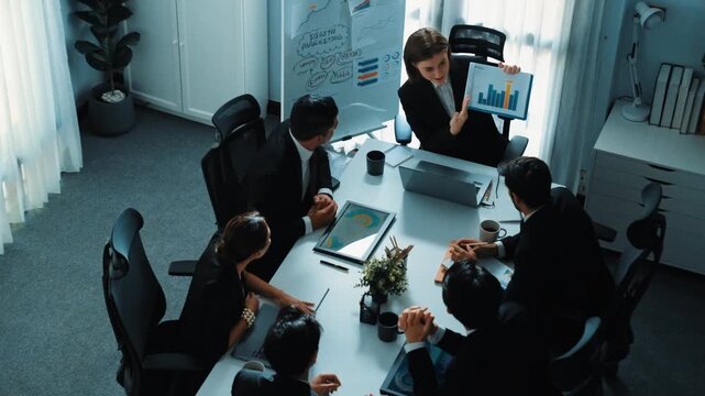 Top view of smart business woman show increasing sales chart to diverse team while group of diverse business people listening and analyzing stock investment data at table with document. Directorate. - Powered by Adobe