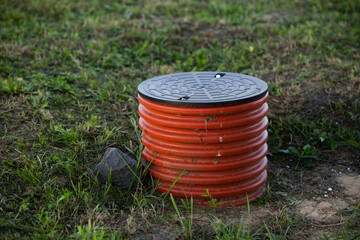 Orange Corrugated Drainage Pipe (Manhole) in the Garden