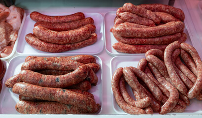 Sausages bufifarra made of pork and chicken minced meat ready for grilling in meat shop