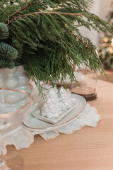 Christmas table decoration with a salt and pepper shaker in the shape of a Christmas tree.
