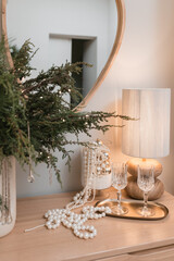 Christmas table decoration with pearl necklace and christmas tree.
