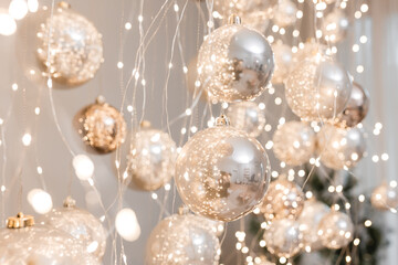 Silver and golden christmas balls with garland with lights. Christmas mood concept for background