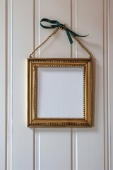 An empty golden frame hanging on a pristine white wall suggests potential and creativity, inviting the viewer to envision the art that could fill this elegant space.