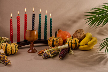 Festive Kwanzaa Setting. A warm Kwanzaa scene with a kinara, fruits, and vegetables