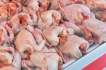Fresh whole chickens in the window of a butcher shop, prepared for sale close up. Meat department in a supermarket with fresh products