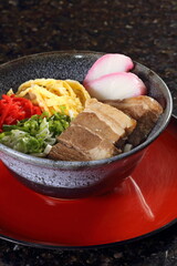 Okinawa Soba, a typical Japanese dish with buckwheat noodles, omelet, meat, soy sauce, and hondashi seasoning.