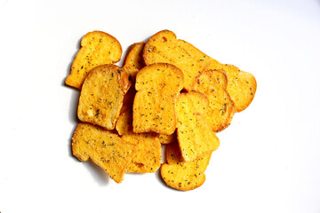 Crispy garlic bread slices on white background.