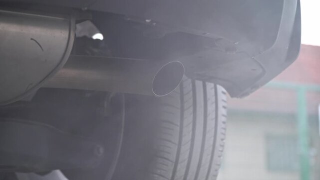 Car engine starts, a lot of smoke comes from the exhaust pipe, sound of the running engine. It stalls and spits out liquid from the exhaust system.