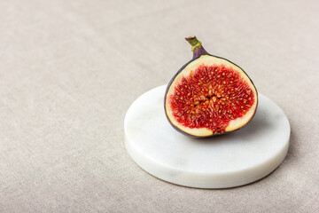 Fresh cut fig on a light background.