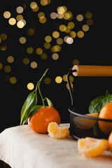 Tangerines and slices with basket on festive table