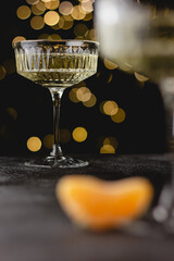 Crystal champagne glasses with golden bokeh background