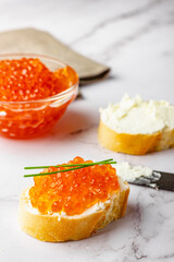 Sandwich with red caviar and soft cheese preparation process