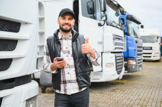 Confident truck driver using smartphone showing thumbs up
