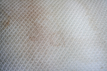Obraz premium Detailed close-up showcases the texture of a quilted fabric. The subtle patterns, dirt details, and natural light highlight its depth and tactile nature, providing a versatile backdrop or element.