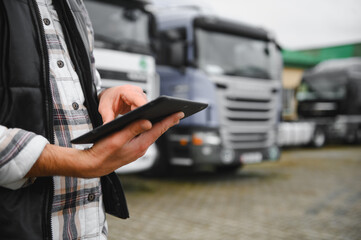 Truck fleet manager working on tablet managing logistics © Serhii