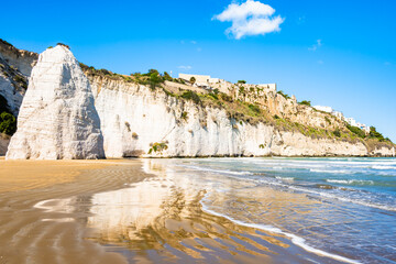 Iconic white cliffs and Pizzomunno rock rising from the sandy beach of Vieste on Italy’s Adriatic coast, Apulia, Italy