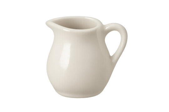 White ceramic creamer jug pouring liquid dairy