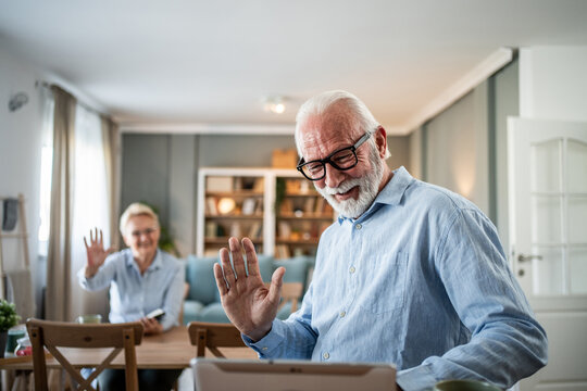 Senior couple enjoying video call with family and friends