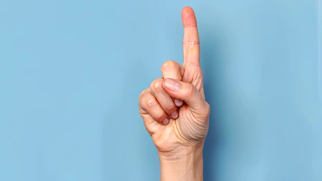 Hand Pointing Upwards: A close-up shot of a hand with the index finger extended upwards, set against a calm backdrop, symbolizing direction, instruction, or a point of emphasis. 