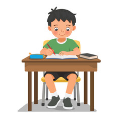 Little boy studying sitting at the desk writing on notebook doing homework