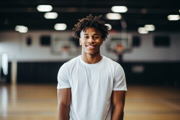 Teen boy smiling in a basketball gym