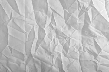 texture captures the full frame of a crumpled white synthetic textile, light and shadow across the textured background.