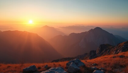 Scenic photo shows mountain range at sunset. The sun shines brightly over peaks creating warm atmosphere. Nature landscape has great view on the horizon.