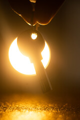 hand holding keys. man taking key to the new home. Male holding keys from new apartment. Light background. Keys concept.