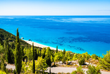 View of pine trees on sea coast and beautiful Avali beach with tuquoise water, Lefkada island, Greece