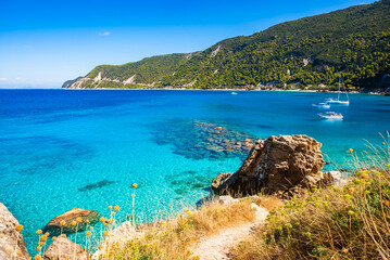 Rocks and stones in crystal clear turquoise sea water of Agios Nikitas beach, Lefkada island, Greece