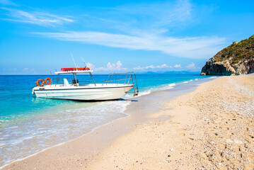 Motor boat anchoring on Milos beach, Lefkada island, Greece