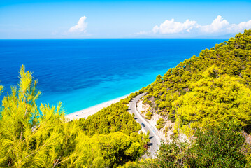 Road to amazing sea coast with pine trees on cliffs, Lefkada island, Greece