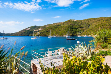 Chairs on terrace with beautiful view of Mikros Gialos bay, Lefkada island, Greece