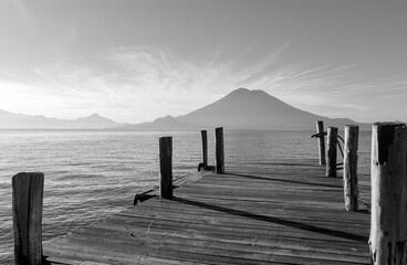 wooden dock pier at lake atitlan in guatemala (volcanic caldera crater) deepest lake in central...