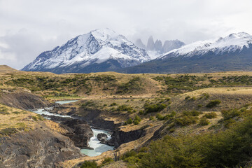 wide view of rapids on the paine river with the three towers in the distance