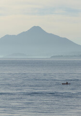 Obraz premium morning sunrise view of volcanos on lake atitlan (volcanic mountains at daybreak) volcano water guatemala glow horizon travel tourism central america