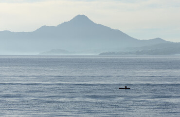 morning sunrise view of volcanos on lake atitlan (volcanic mountains at daybreak) volcano water guatemala glow horizon travel tourism central america