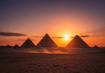 Stunning sunset illuminates the Great Pyramids of Giza in golden light