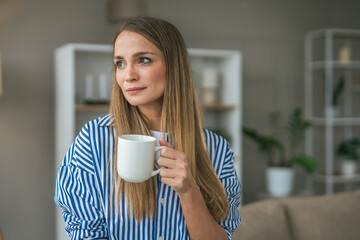 Beautiful woman drink coffee and enjoy at her living room