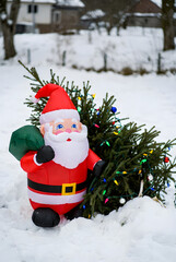 Inflatable Santa Christmas decoration outdoors in snowy yard