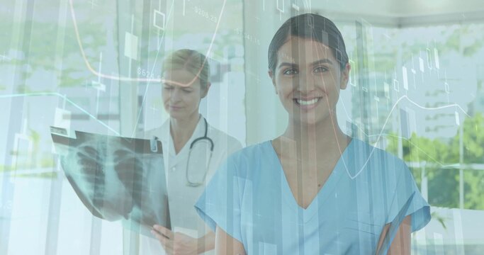 Smiling nurse in blue scrubs standing in clinic, physician in white coat reading chest xray, charts - Powered by Adobe