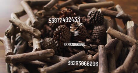 Displaying centered driftwood wreath holding aged pinecones on wooden table, with barcode watermark