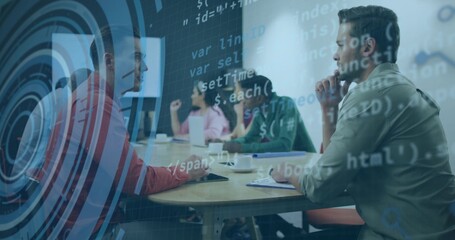 Male at right reviewing code-target overlay in meeting room with laptop, casual-shirt, copy space